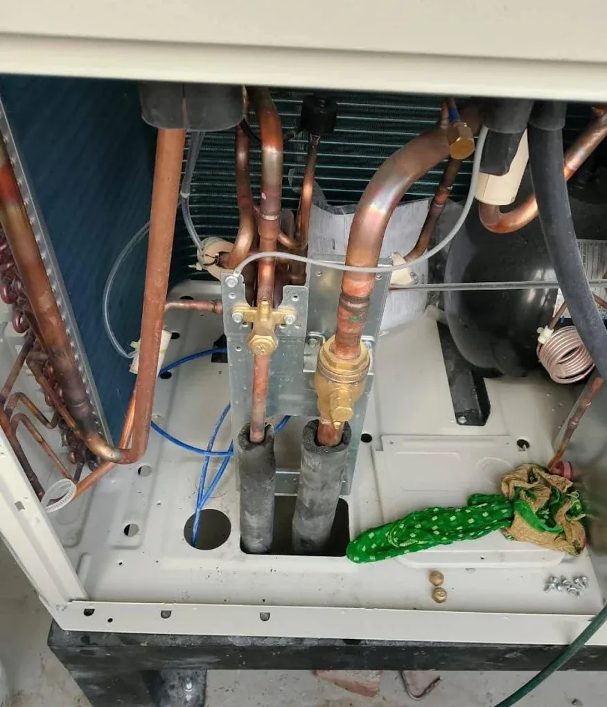 Copper refrigerant pipes and service valves inside an AC unit