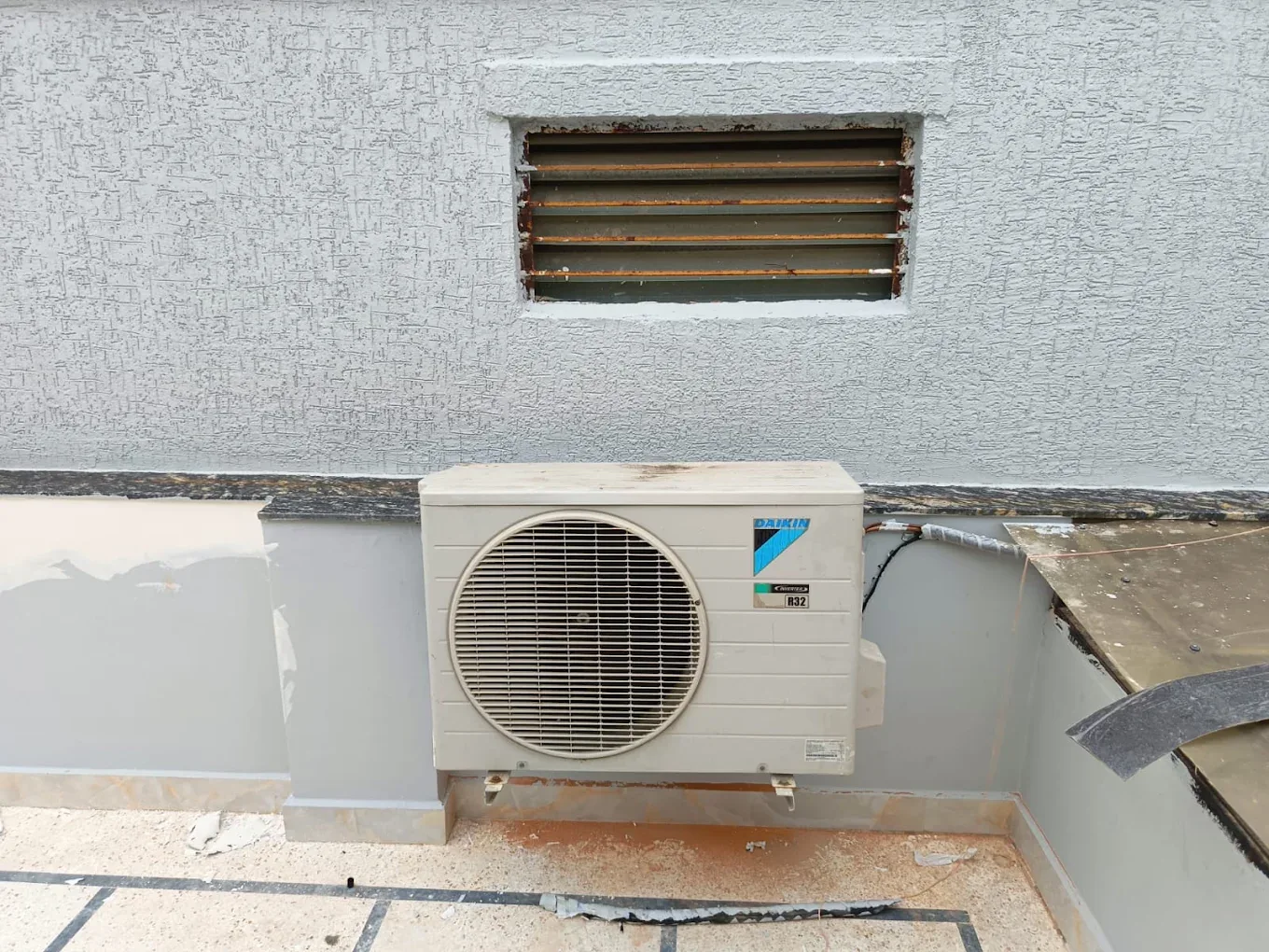Daikin split AC outdoor unit mounted on a terrace